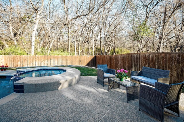 view of patio / terrace with a pool with hot tub