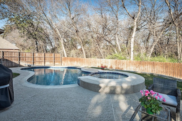 view of pool with an in ground hot tub