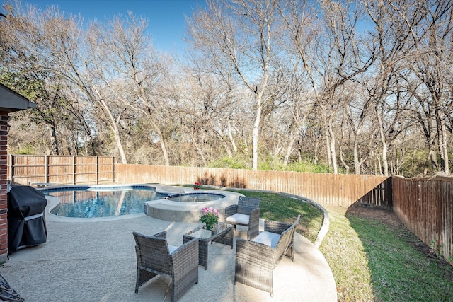 view of swimming pool featuring grilling area and an in ground hot tub