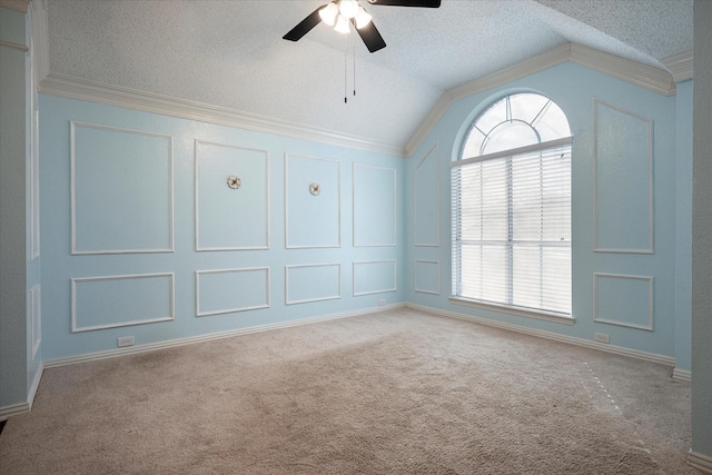 spare room featuring light carpet, a textured ceiling, ceiling fan, crown molding, and lofted ceiling