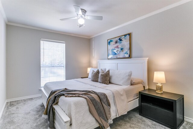 carpeted bedroom with ceiling fan and crown molding