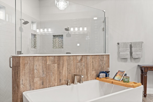 bathroom featuring shower with separate bathtub