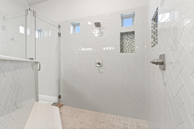 bathroom featuring tile patterned flooring and an enclosed shower