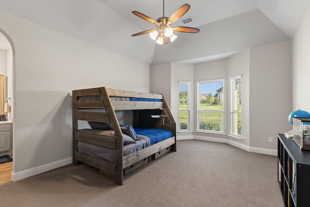 bedroom with ceiling fan, carpet, and vaulted ceiling