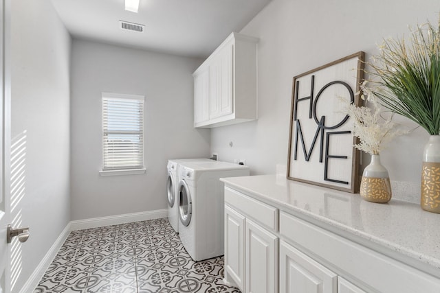 washroom featuring washer and clothes dryer, light tile patterned floors, and cabinets