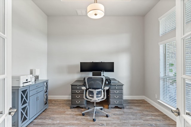 office with light wood-type flooring