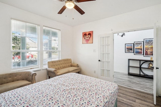 bedroom featuring hardwood / wood-style floors, ceiling fan, and french doors