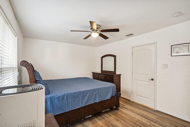 bedroom with ceiling fan and hardwood / wood-style flooring