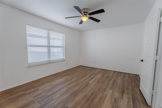 empty room with ceiling fan and wood finished floors