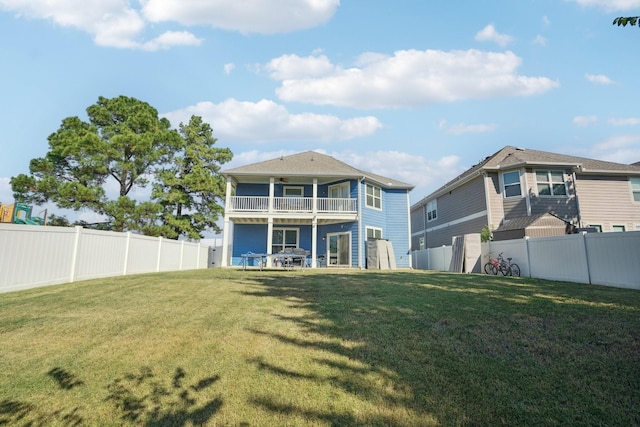 back of property featuring a lawn and a balcony