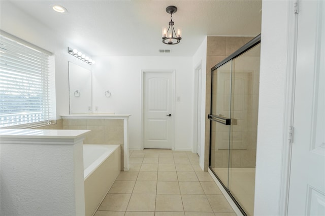 bathroom featuring a chandelier, tile patterned flooring, visible vents, a shower stall, and a bath