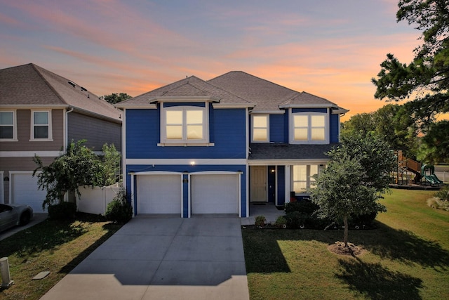 front of property featuring a garage and a yard