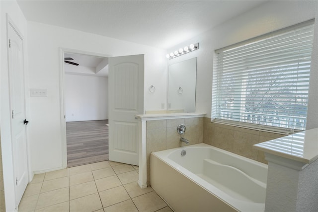 full bath featuring a garden tub and tile patterned floors