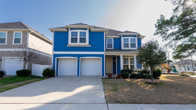 view of front of property featuring a playground, concrete driveway, an attached garage, and fence