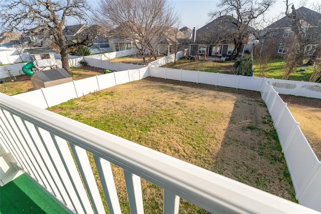 view of yard featuring a fenced backyard and a residential view