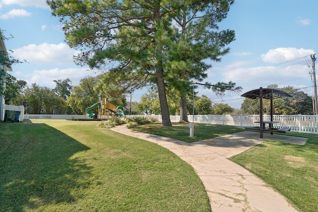 surrounding community with a playground and a yard