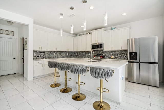 kitchen featuring white cabinetry, hanging light fixtures, stainless steel appliances, and sink