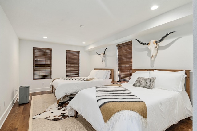 bedroom with dark hardwood / wood-style flooring