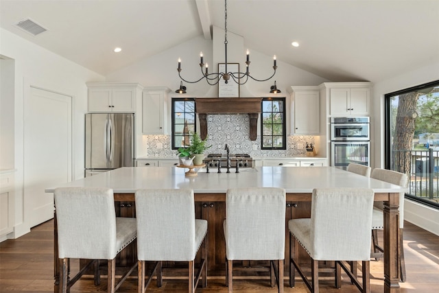 kitchen featuring white cabinets, a spacious island, and appliances with stainless steel finishes