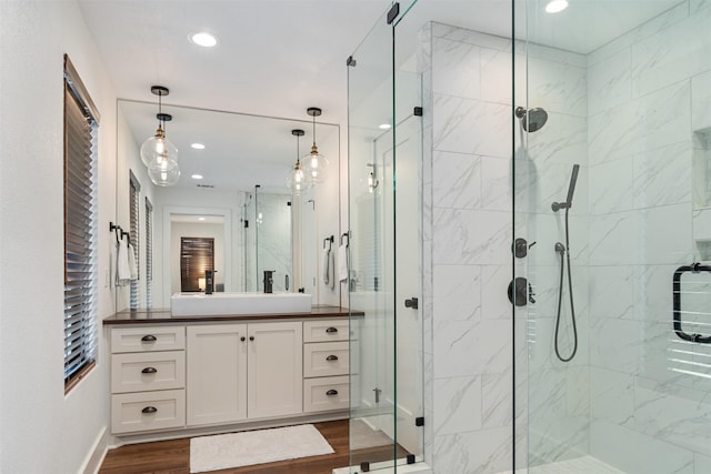 bathroom with vanity, wood-type flooring, and walk in shower