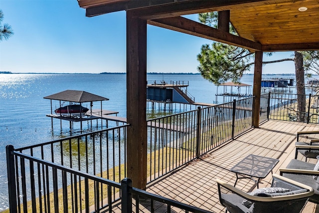 view of patio / terrace with a water view and a dock