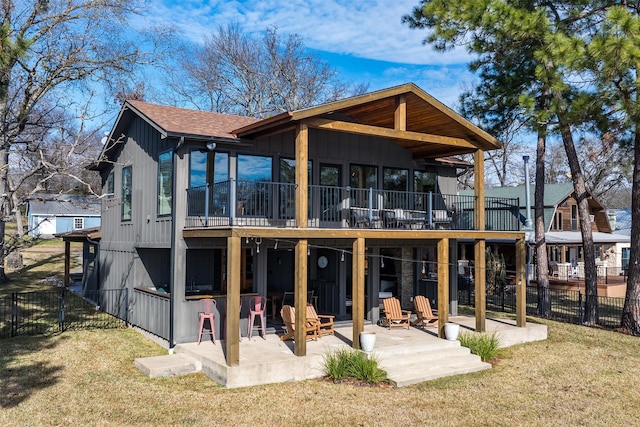 back of house featuring a patio area and a lawn