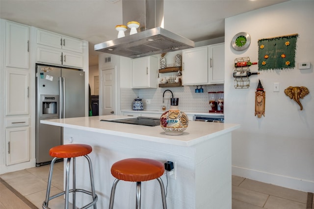 kitchen with backsplash, appliances with stainless steel finishes, a kitchen island, white cabinetry, and island exhaust hood