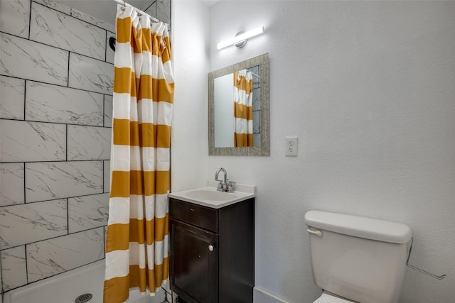 bathroom with vanity, toilet, and curtained shower