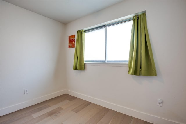 unfurnished room with light wood-type flooring