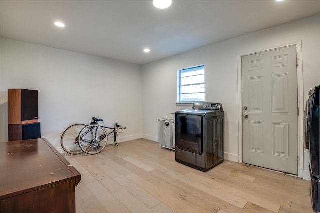 washroom with washer / clothes dryer and light wood-type flooring