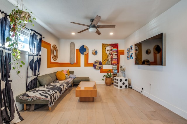 living room with hardwood / wood-style flooring and ceiling fan