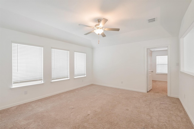 carpeted empty room featuring vaulted ceiling and ceiling fan