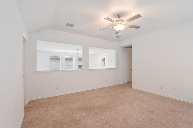 empty room with ceiling fan, light colored carpet, and lofted ceiling