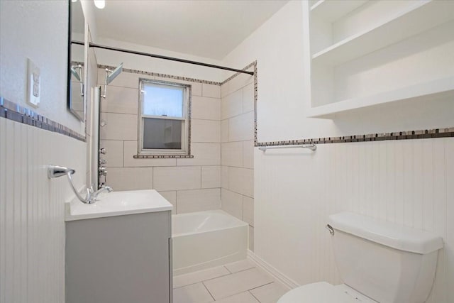 full bathroom featuring vanity, tiled shower / bath combo, tile patterned floors, and toilet