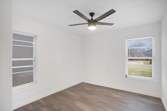 unfurnished room featuring dark wood-type flooring and ceiling fan