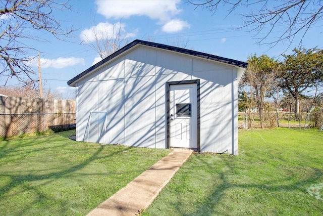 view of outdoor structure featuring a lawn