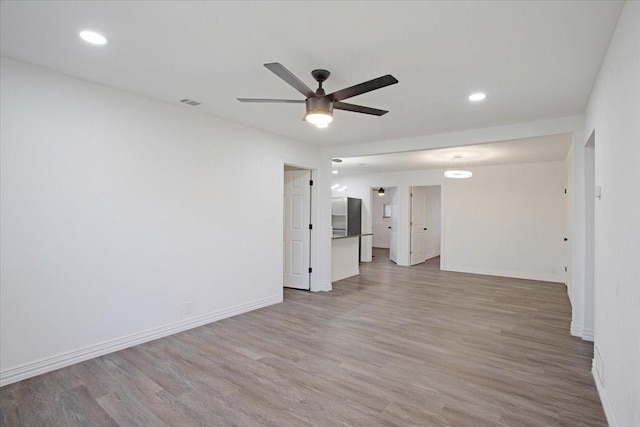 unfurnished room featuring ceiling fan and light hardwood / wood-style flooring