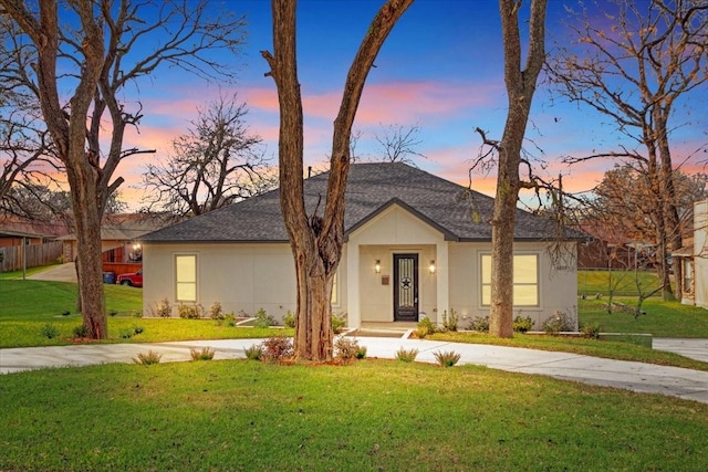 ranch-style house featuring a yard