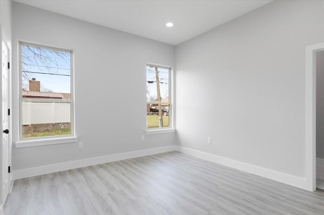 spare room with light hardwood / wood-style flooring