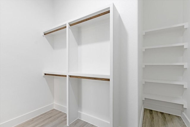 walk in closet featuring light hardwood / wood-style flooring