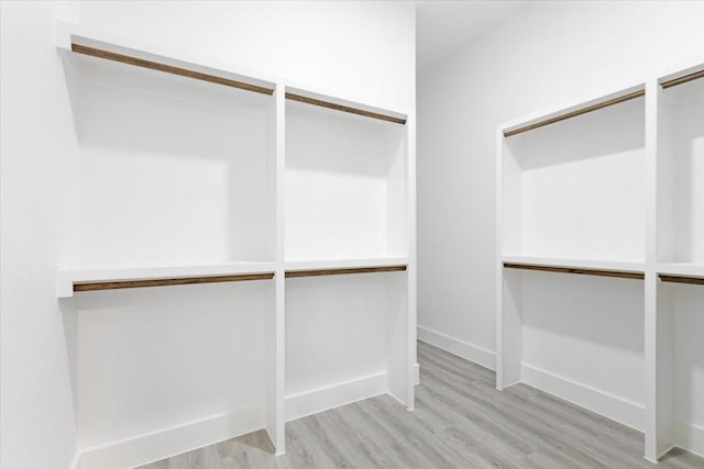 walk in closet featuring light hardwood / wood-style flooring