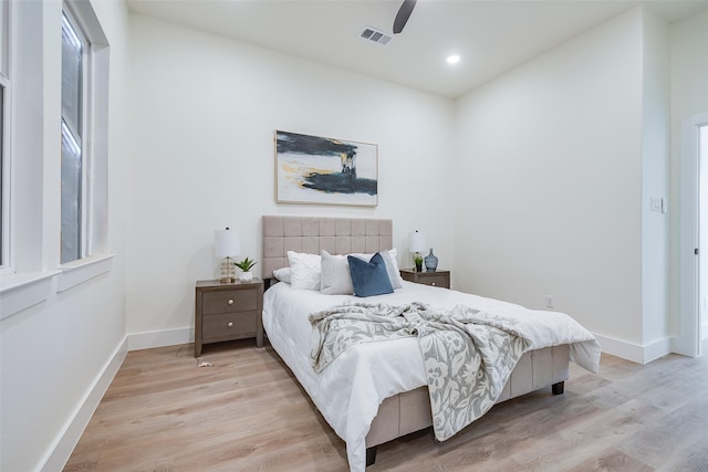 bedroom with ceiling fan and light wood-type flooring