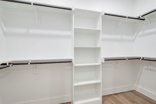 walk in closet featuring light hardwood / wood-style flooring