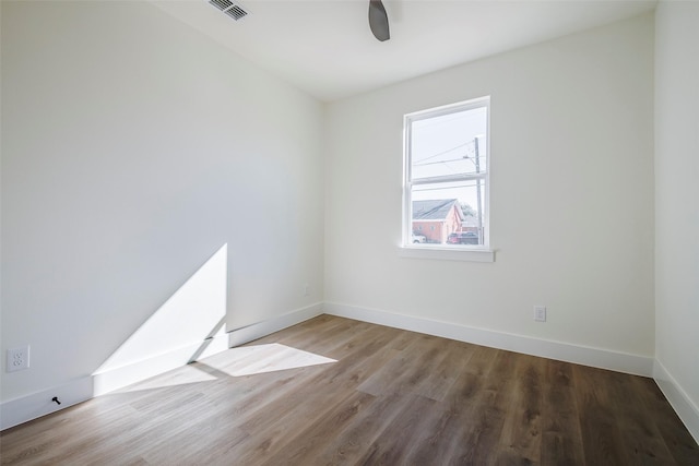 unfurnished room with hardwood / wood-style flooring