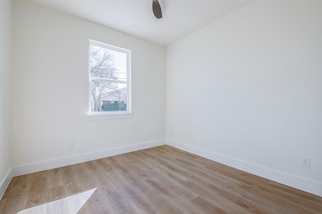 spare room with ceiling fan and light wood-type flooring