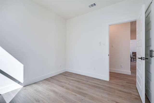 empty room with light hardwood / wood-style flooring