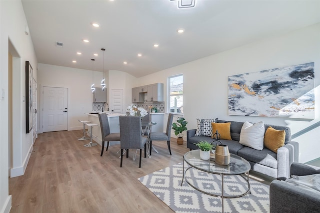 living room with sink and light wood-type flooring