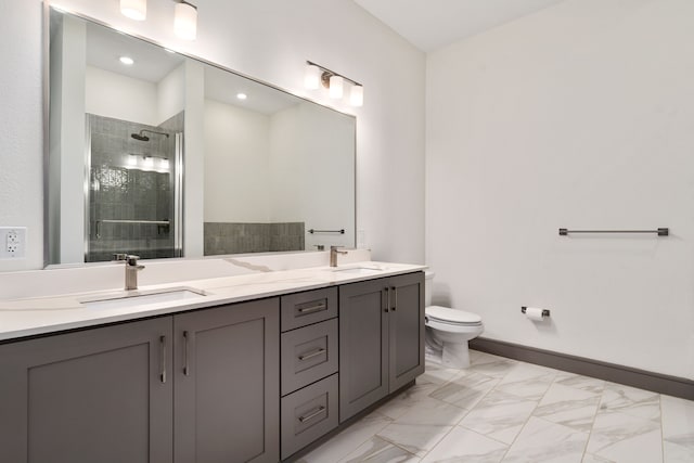 bathroom featuring a shower with door, vanity, and toilet