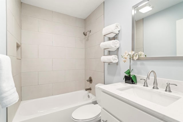 full bathroom featuring vanity, toilet, and tiled shower / bath