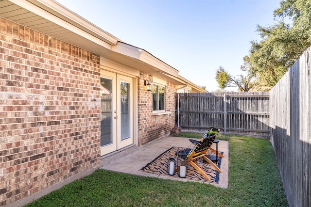 view of yard with a patio and french doors